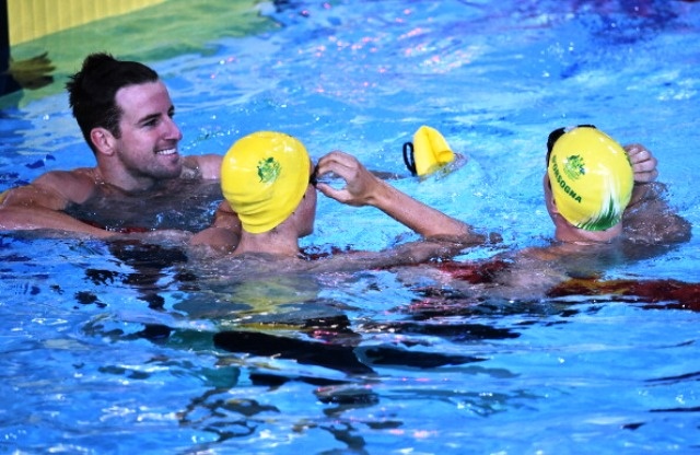 (L-R) Australia's James Magnusson, Australia's Cameron McEvoy and Australia's Tommaso D'Orsogna celebrate a clean sweep in the Men's 100m Freestyle Final at the Tollcross International Swimming Centre during the 2014 Commonwealth Games in Glasgow on July 27, 2014.  AFP PHOTO / ANDREJ ISAKOVIC        (Photo credit should read ANDREJ ISAKOVIC/AFP/Getty Images)