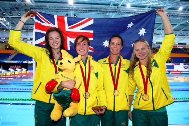 GLASGOW, SCOTLAND - JULY 24:  (L-R) Cate Campbell, Bronte Campbell, Emma McKeon and Melanie Schlanger of Australia celebrate winning the gold medal after the medal ceremony for the Women's 4 x 100m Freestyle Relay Final in a world record time at Tollcross International Swimming Centre during day one of the Glasgow 2014 Commonwealth Games on July 24, 2014 in Glasgow, Scotland.  (Photo by Cameron Sp
