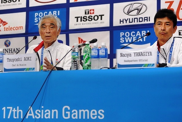 Tsuyoshi Aoki (L), Japan's chief of mission, speaks during a press conference as Naoya Yanagiya (R), Japanese headquarters official, listens following the announcement that a Japanese swimmer stole a photographer's camera at the poolside during the 17th Asian Games in Incheon on September 27, 2014. Japanese swimmer Naoya Tomita has been expelled from the Asian Games after he admitted stealing the 
